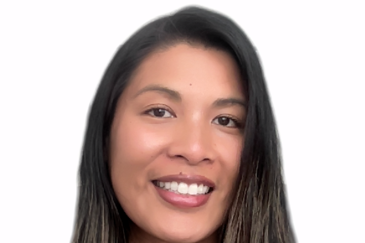 Headshot of Meia, who is looking towards the camera with an open-lipped smile. Meia is a Filipina-American with brown skin and black hair that is partially dyed blonde. She is wearing a red sweater.