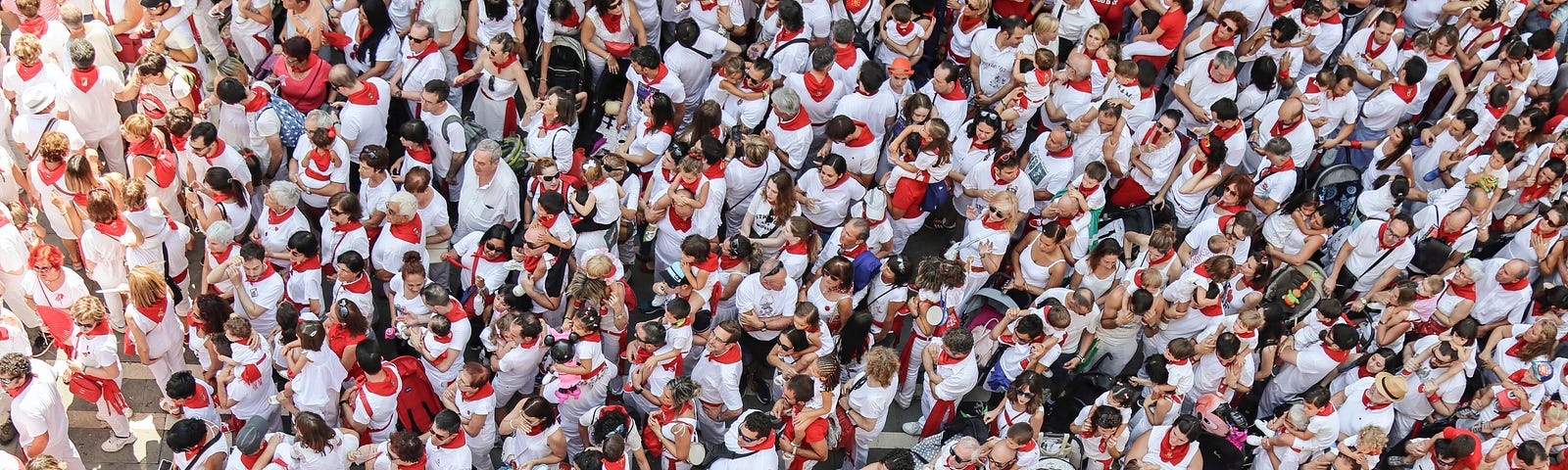 Picture of a crowd (view from above) at San Fermin’s Pamplona — all people wearing whit shirts