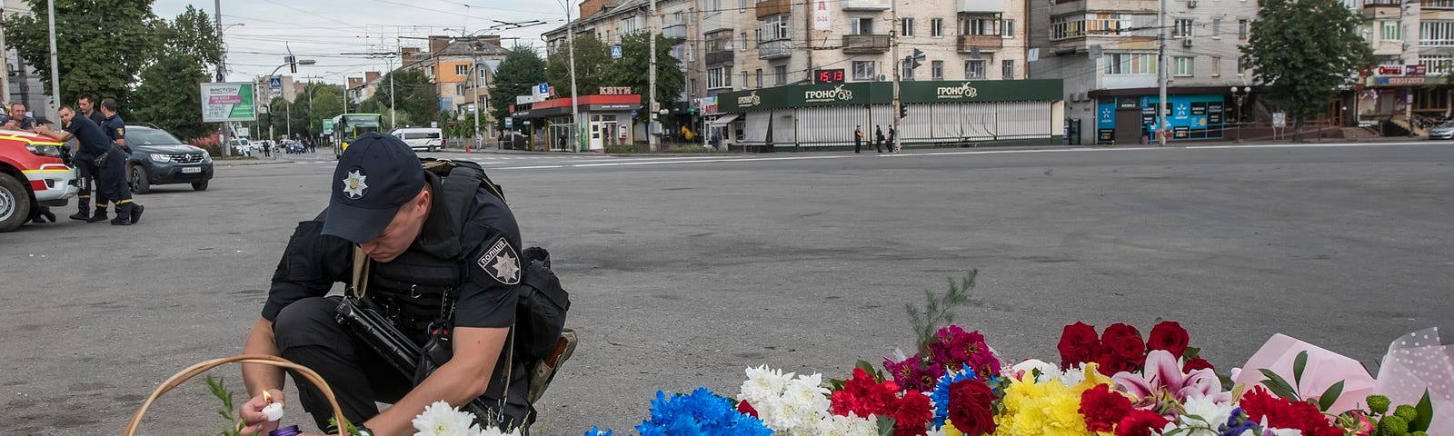 A Ukrainian serviceman lights a candle at the spot where a child was killed by a Russian cruise missile strike in Vinnytsia, Ukraine, July 15, 2022. Photo by Maxym Marusenko/Reuters