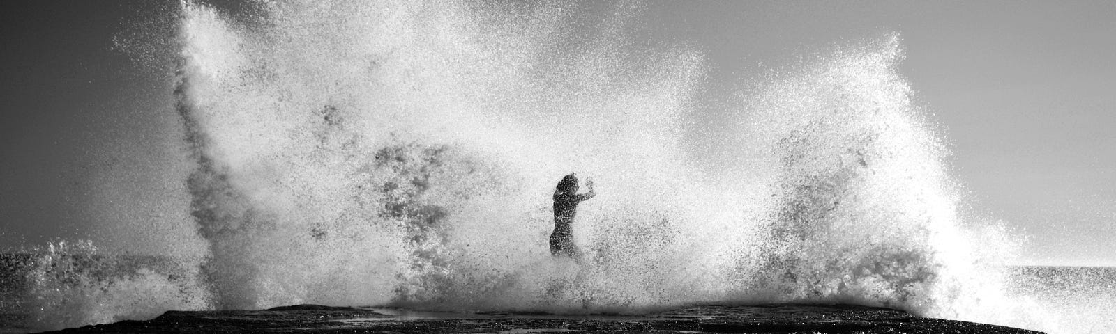 Gigantic wave crashing over person, black and white, nostalgic feel