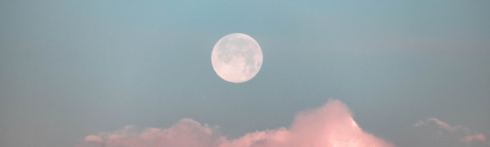 The moon over pink mountains.