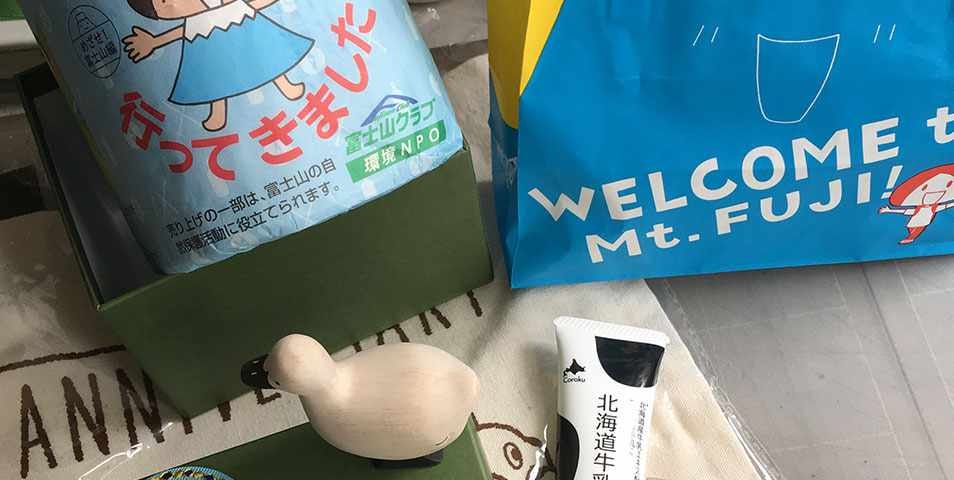 A Japanese souvenir set consists of a Fuji mountain-illustrated toilet roll, a fabric pin, a hand lotion, a wooden duck, a pack of instant coffee & a cotton bag.