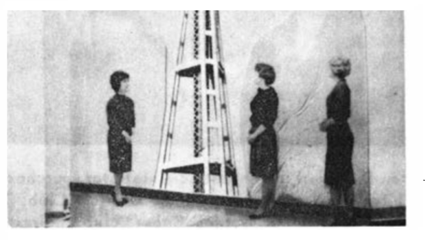 Vassie and others posing with a photograph of the Seattle Space Needle.