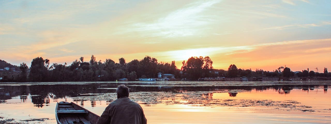 Old man paddling boat