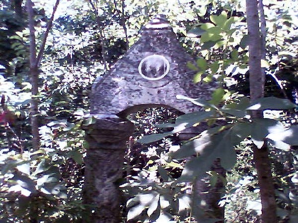 Stone arch in the woods.