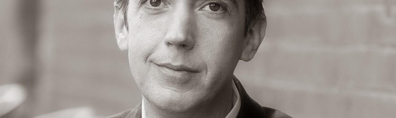 Photo of author wearing a suit