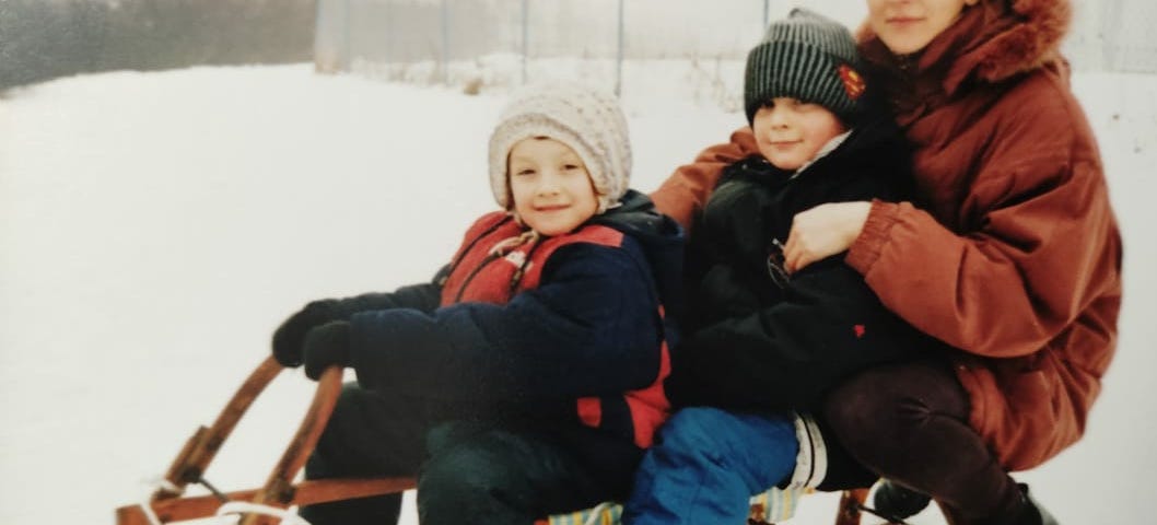 My mom, me and my brother sledding