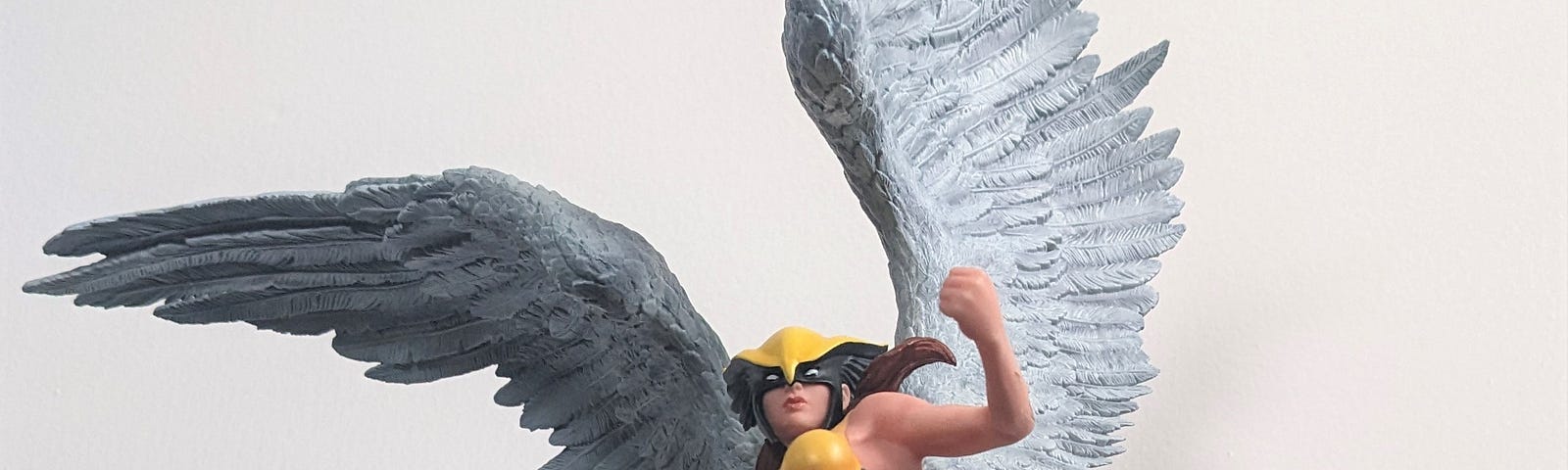 Statues of Spider-Man and Hawkgirl (Shayera Hol) posing.