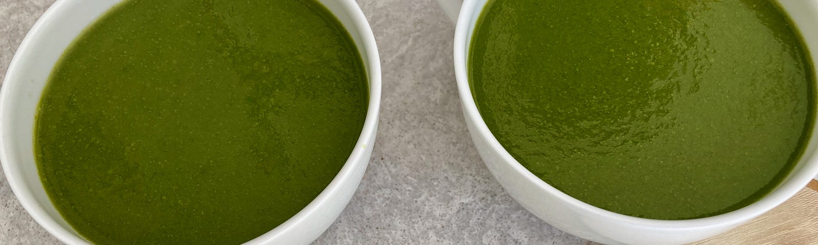 Two bowls of green soup.