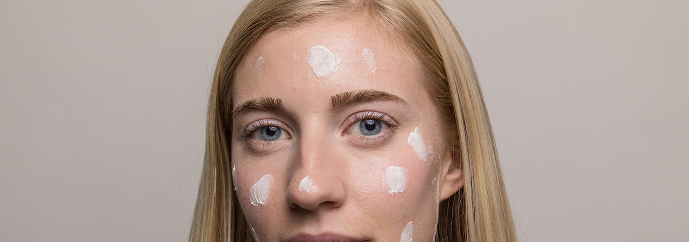 Woman with skincare treatment on her face