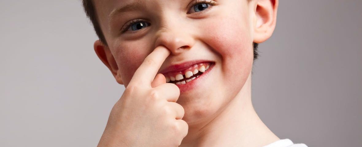 Young boy picking his nose