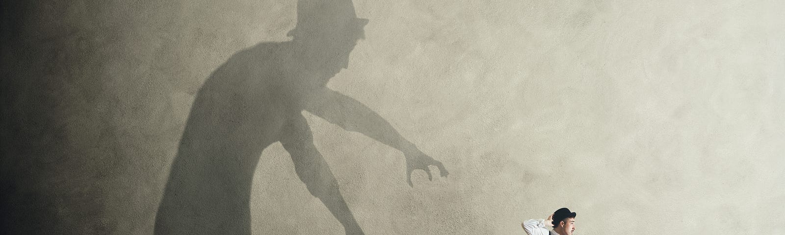 A man running away from his own shadow chasing him.