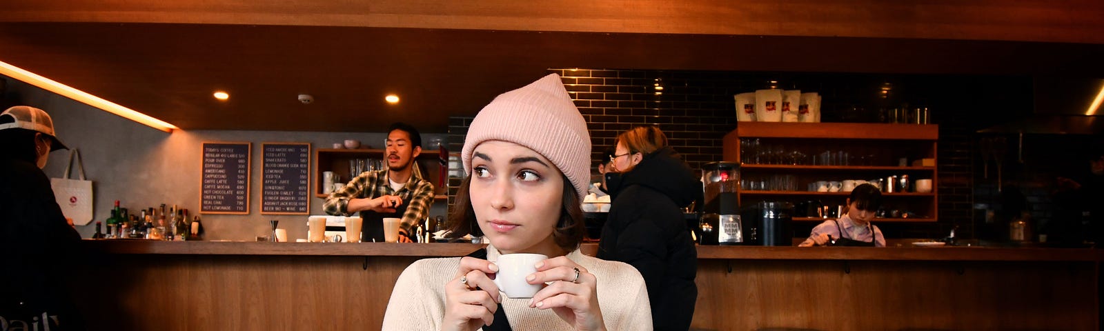 A woman drinking coffee in a cafe.