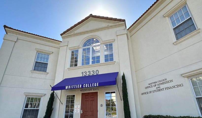 A photo of the Whittier College office of Admission and Office of Student Financing on a bring and sunny day. There is a purple awning over the entrance that reads “Whittier College” in white letters.