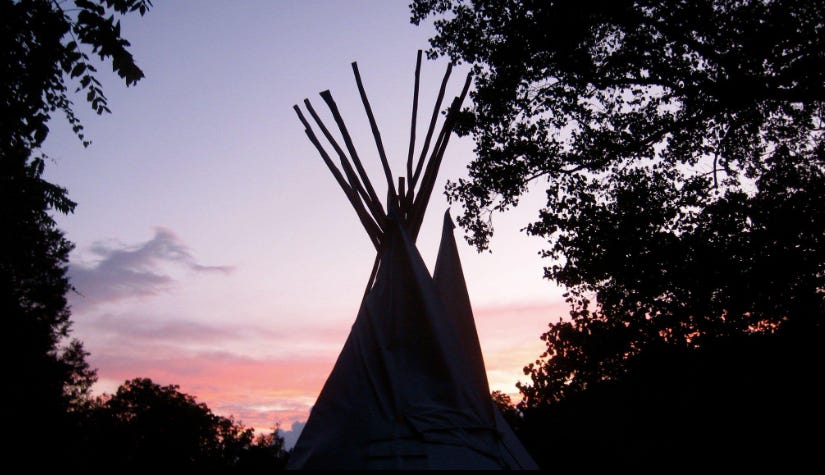 A tipi against the sunset.