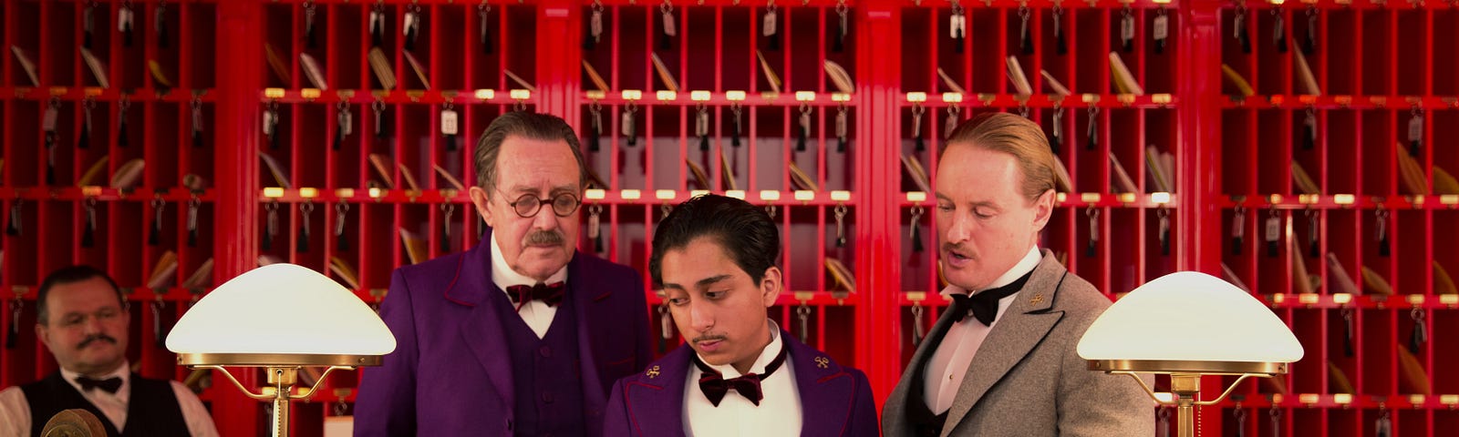 Grand Budapest Hotel clerk stares at a book