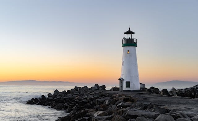 lighthouse at dawn on rocks