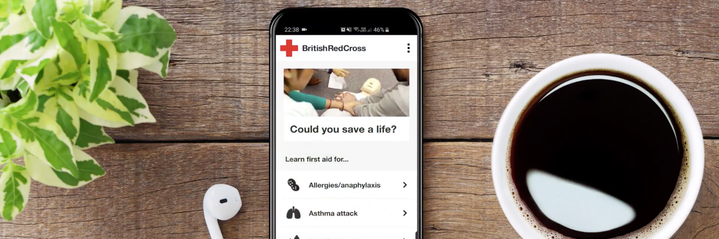 The British Red Cross First aid app is displayed on a phone.