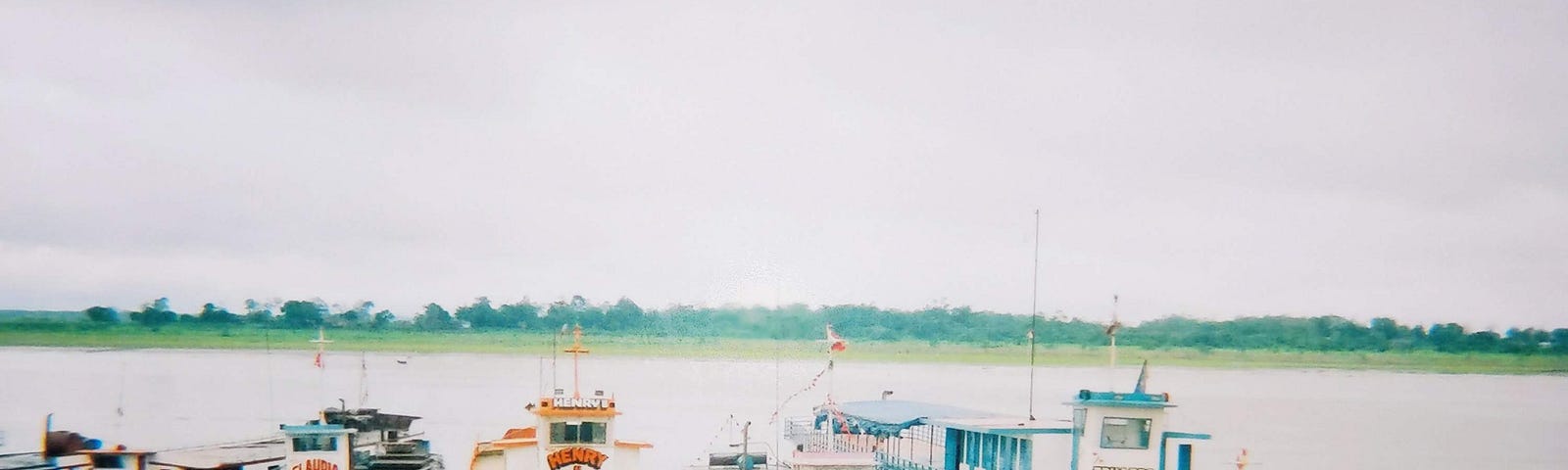 Colourful metal boats moored up on the river at Iquitos in Peru