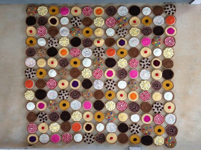 One-hundred and sixty-nine crochet cookies arranged and joined to form a square crochet blanket