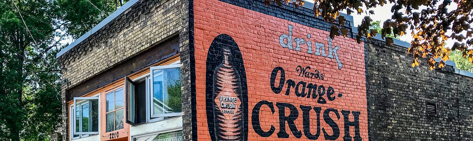 Vintage-style hand painted Orange Crush soda pop sign on a brick building in Minneapolis, Minnesota.