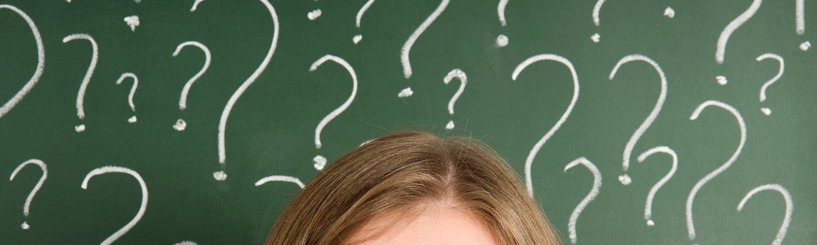 The top half of a white woman’s face is visible at the bottom of the image, looking up into a cloud of question marks. She looks confused at the number of options available to her.