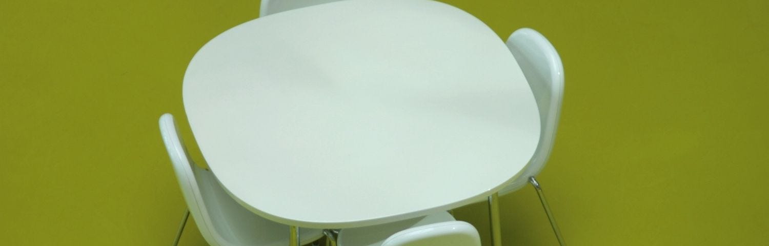 Lunchroom table with four chairs.