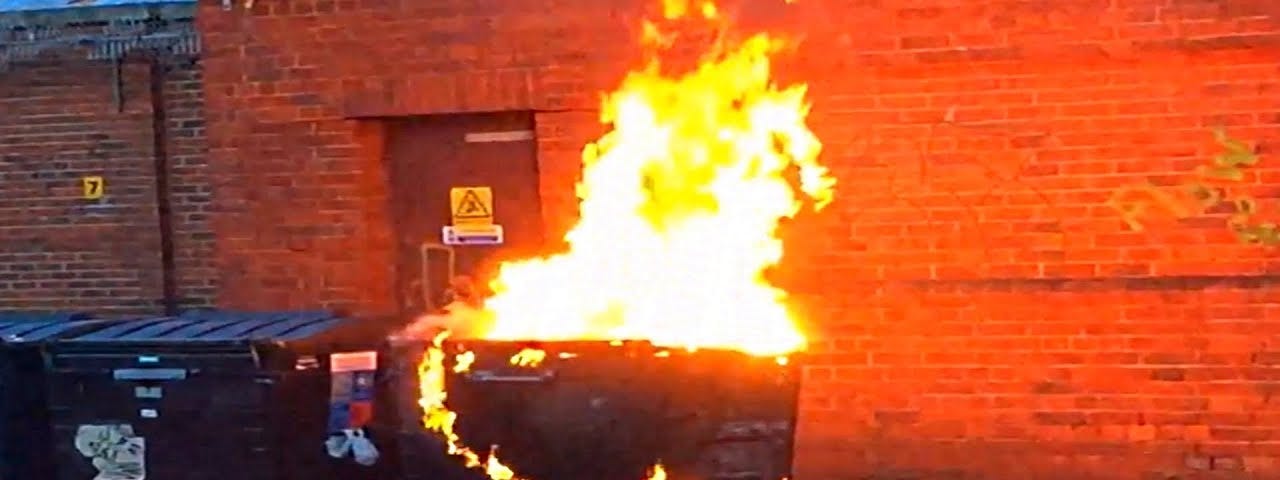 A wheelie bin on fire