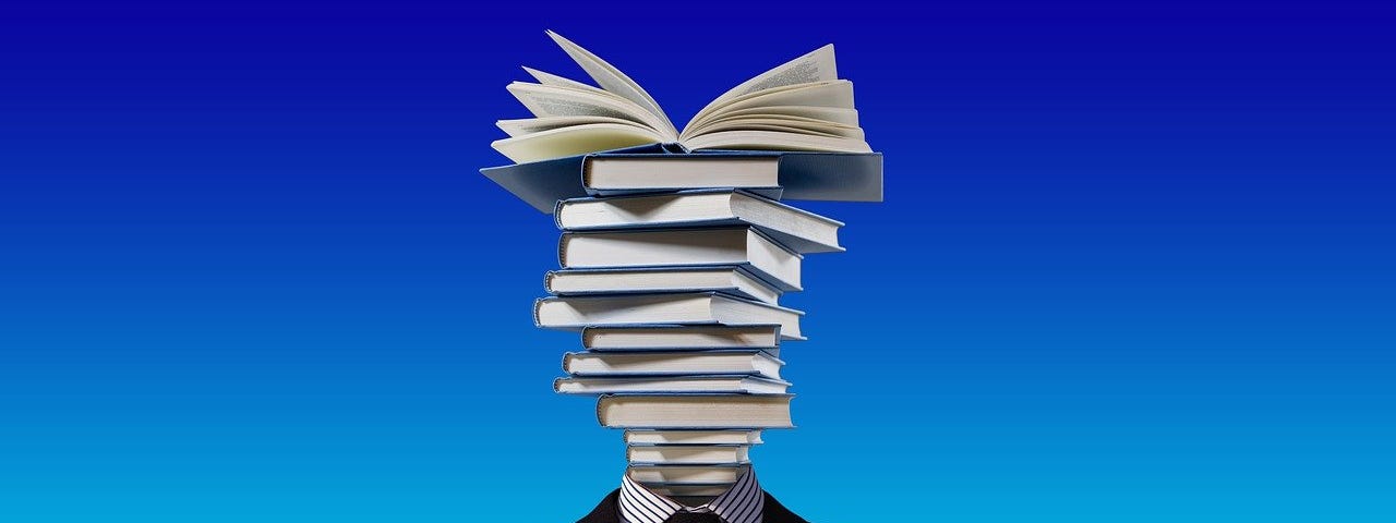 A man in a suit with a stack of books where his head should be