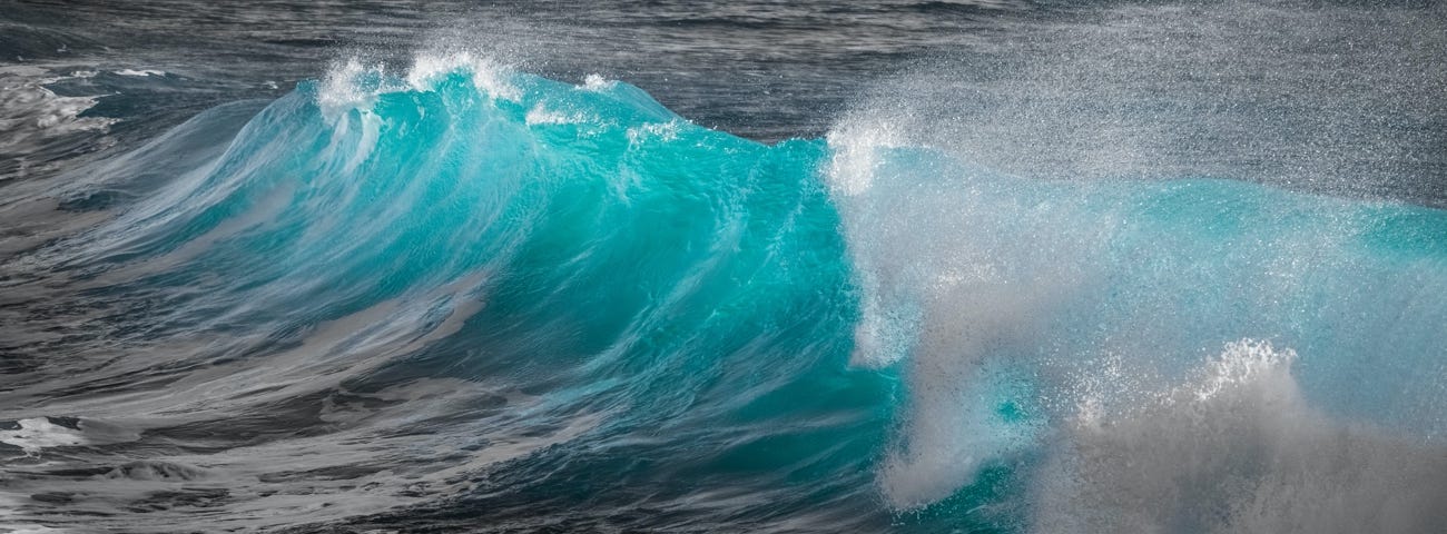 Image: A photo of bright blue ocean wave.