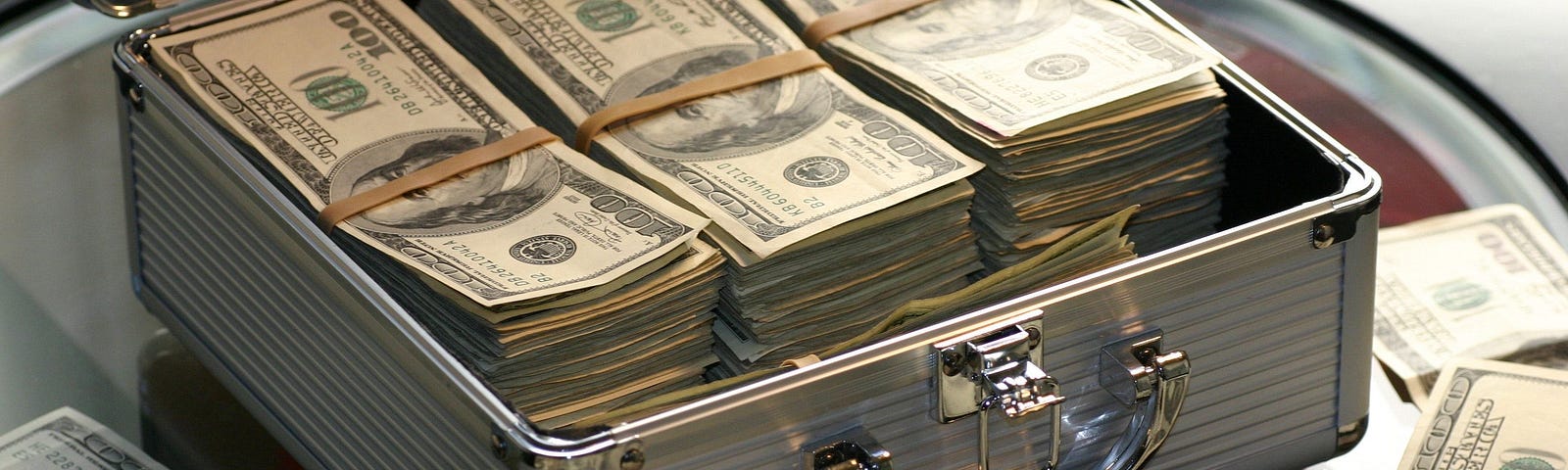 image of money in a case to represent money paid for a data breach settlement.