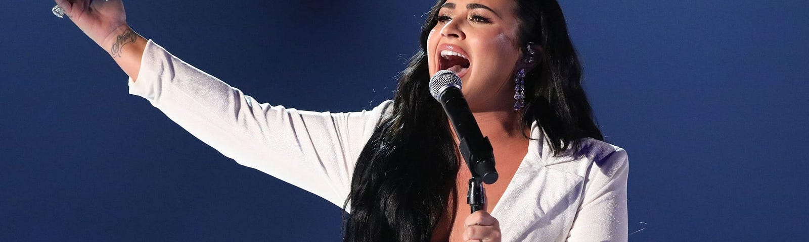 Photo of Demi Lovato singing