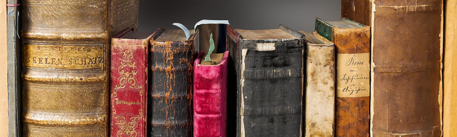 Antique books sitting on a shelf