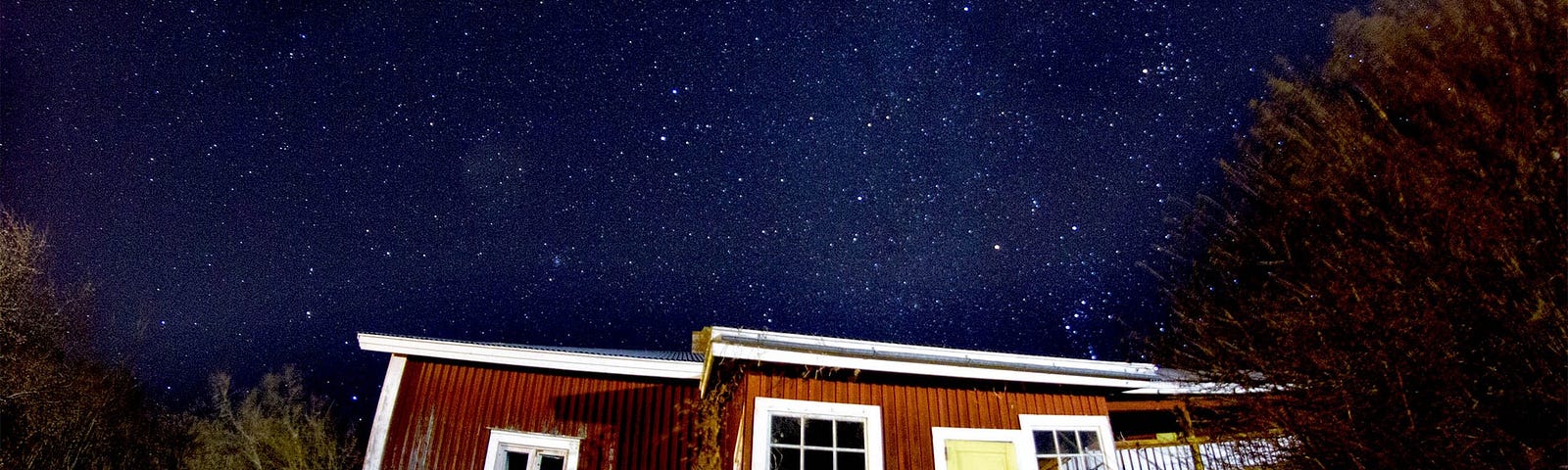 Very small house under a starry sky.