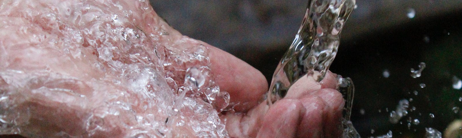 Stream of water flowing through fingertips