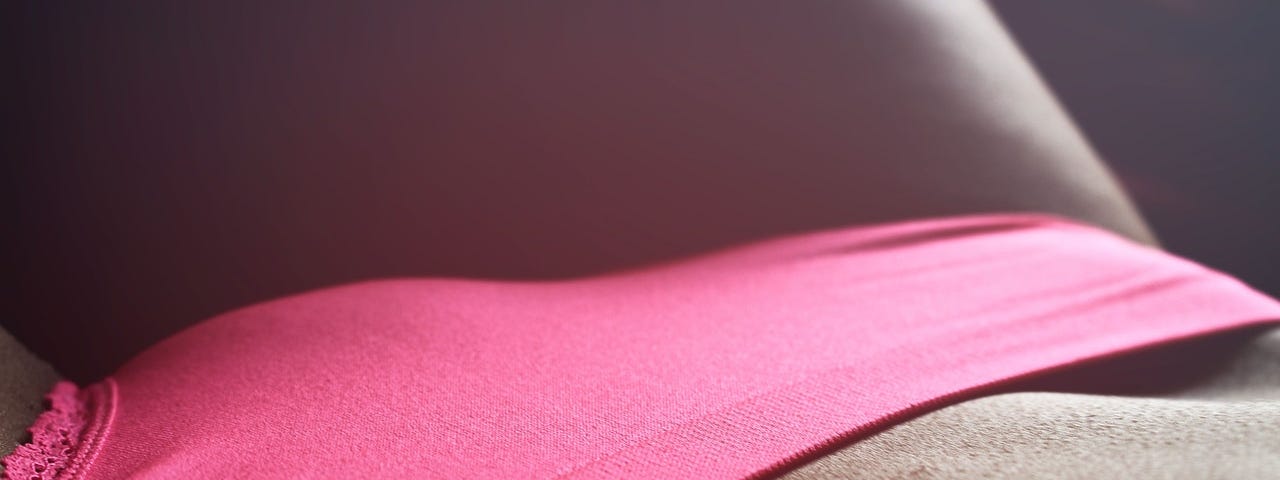 A woman wearing some pink panties