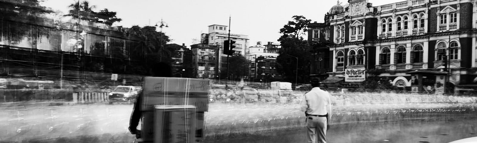 A traffic policeman and a vendor with boxes on his cycle in Mumbai’s fort area