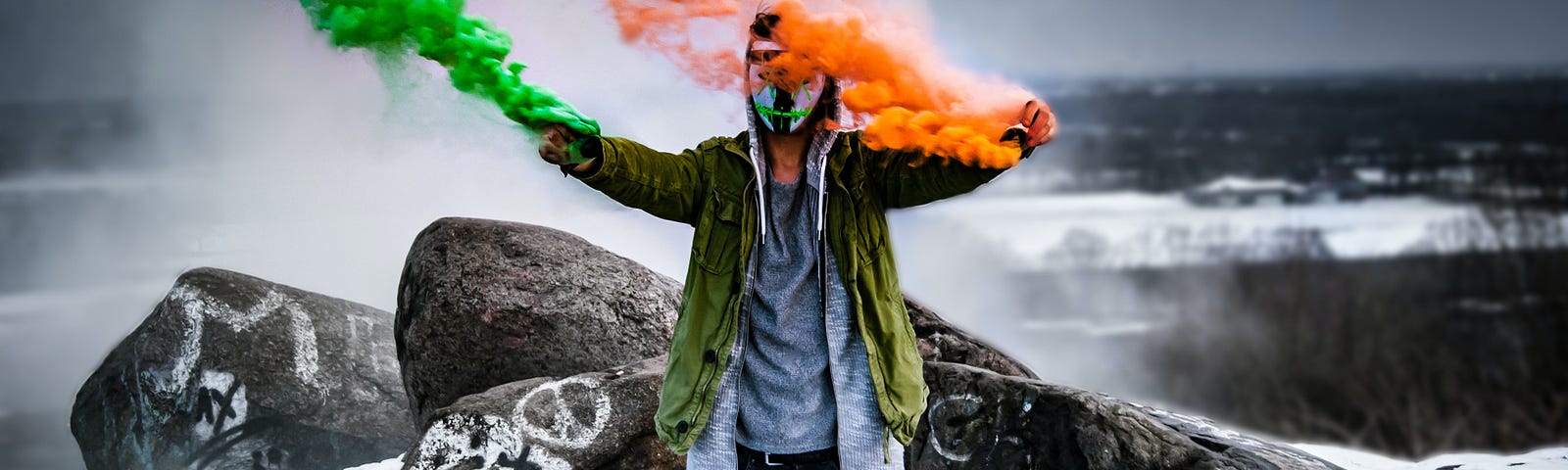 A man holding green and orange flares
