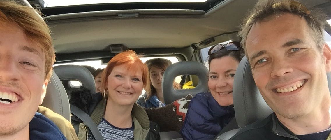 Photo of author taking a selfie with the family who picked him up.