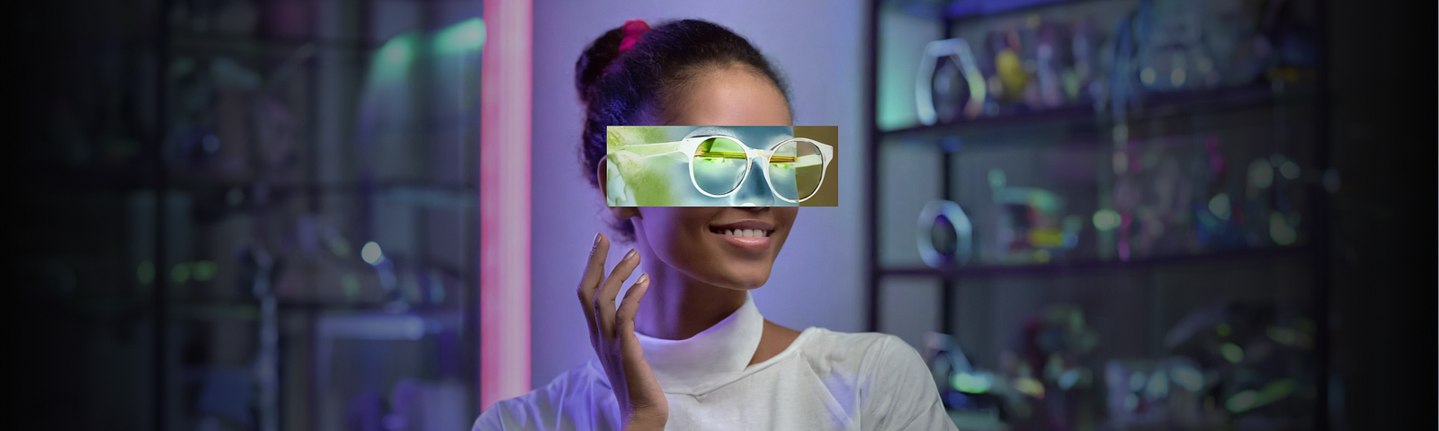 Smiling young woman using augmented reality to try on digital eyeglasses, showcasing the innovative AR technology in eyewear shopping with Designhubz.