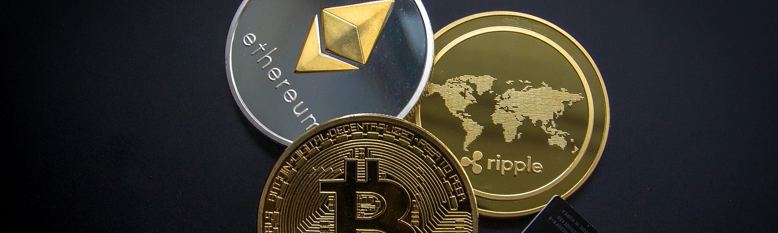 Physical coins representing popular cryptocurrencies