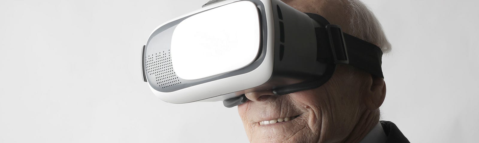 Older man using Virtual Reality goggles