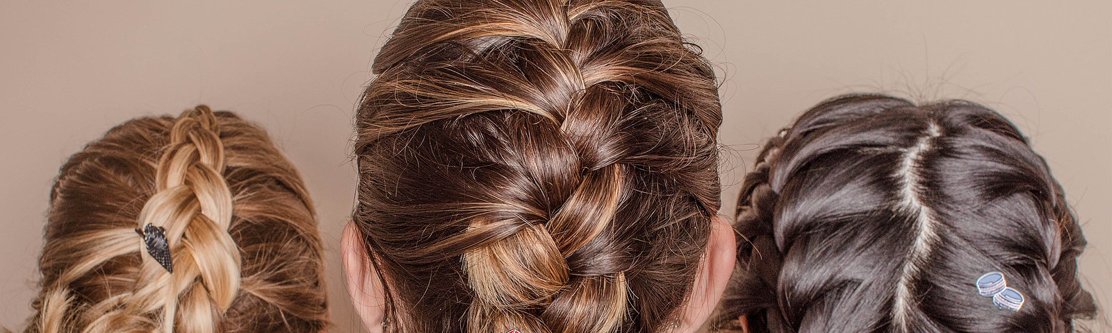 Three women with Curology’s limited-edition pins fastened to their braids