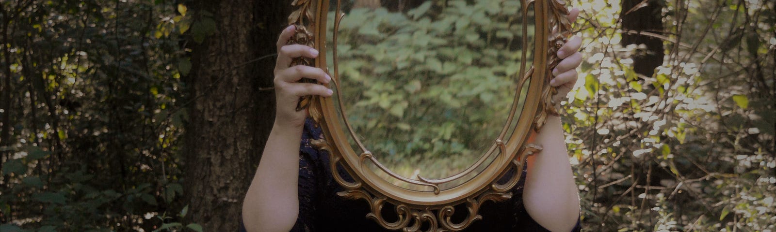 woman, in woods, holding mirror, reflection of self