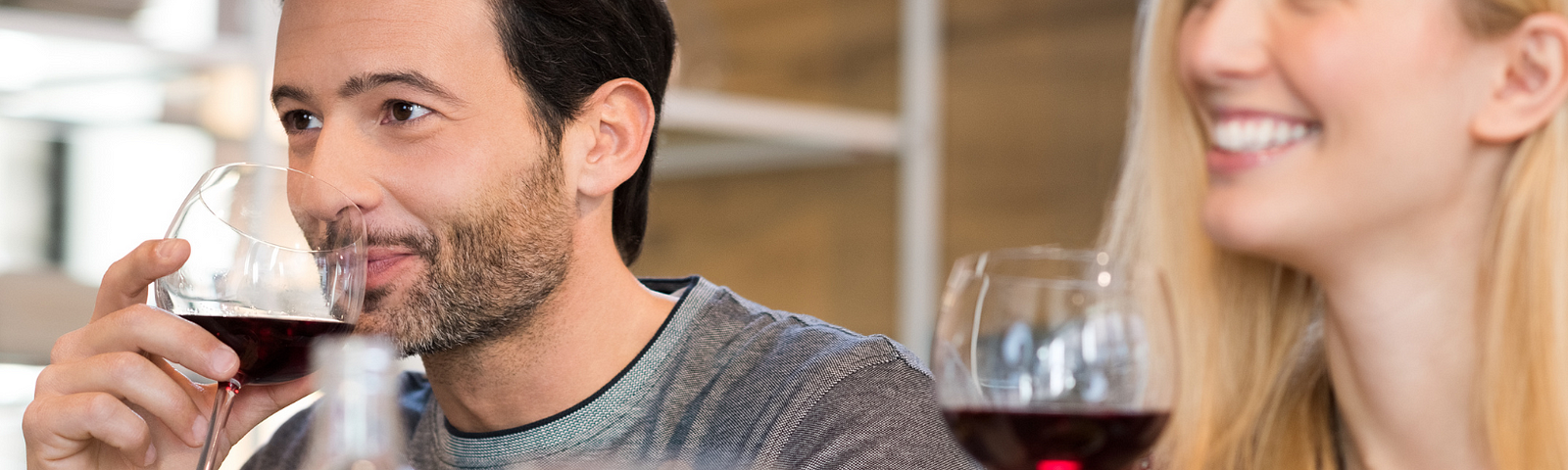 a man and woman drinking wine, oblivious