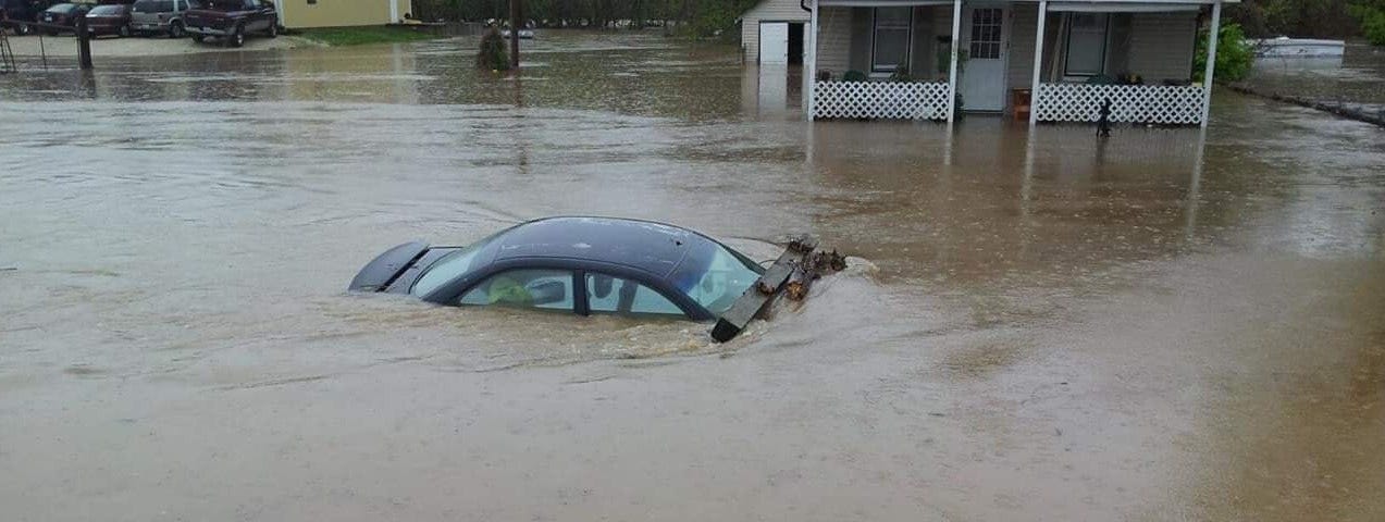 Floodwaters engulf a car near Desoto, Missouri.