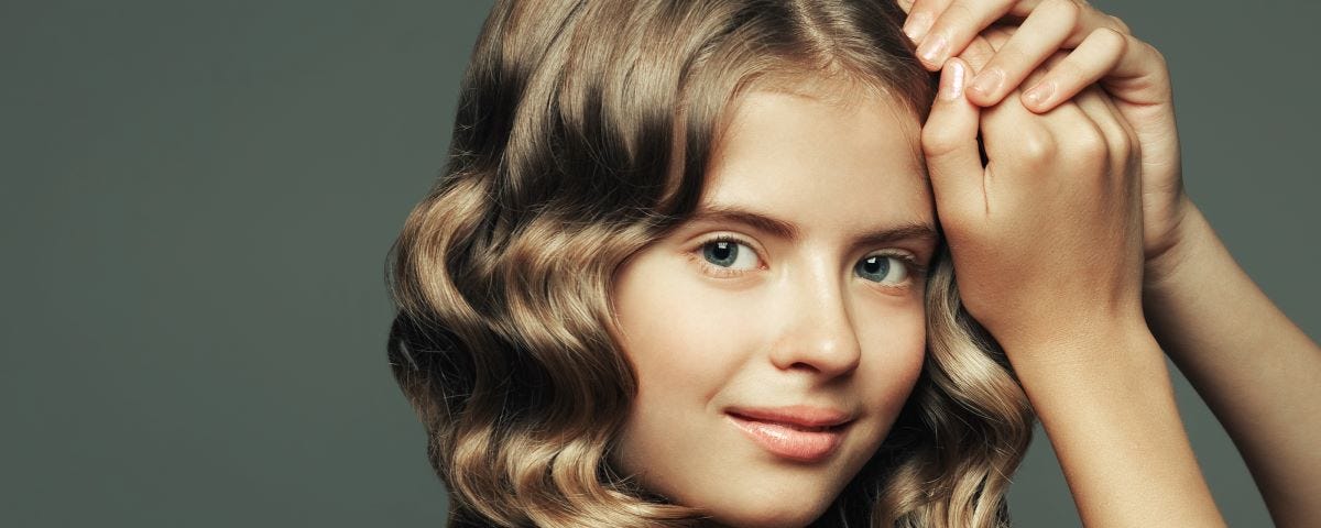 A teenage girl with long wavy fair hair.