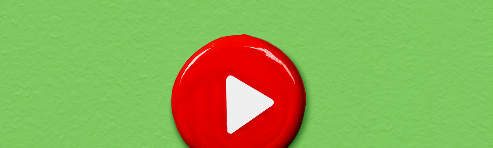 Digital art of the YouTube play button on a green background.