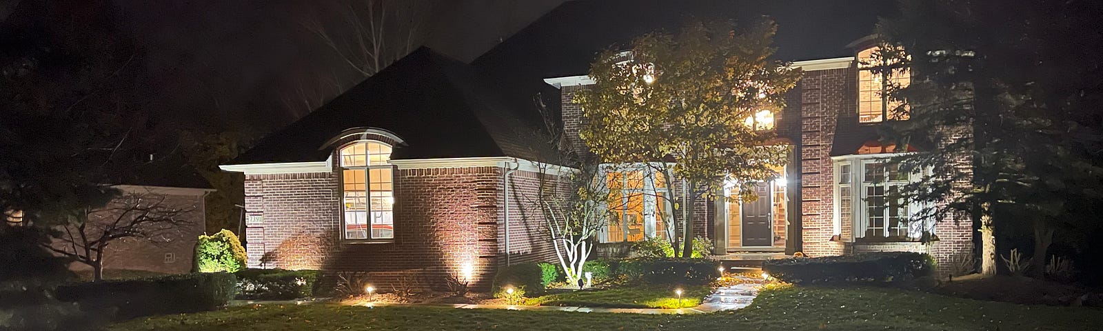 A front view of a fully illuminated house.