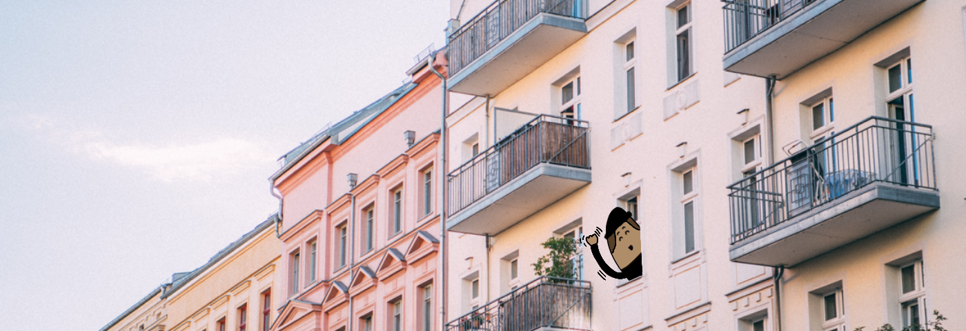 Colorful Prenzlauer Berg Altbau apartments in Berlin, Germany. A Blob wearing a black hat and shirt is sticking its head out of the window and waving.